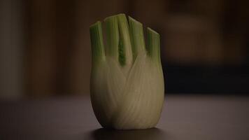 CloseUp Image of a Fresh Fennel Bulb Resting on a Wooden Table Surface for Display video