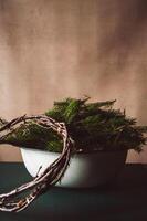Christmas wreath making preparations. Christmas tree branches in a bowl. Rustic style. Concept of homemade decoration for winter holidays. Empty space for text photo