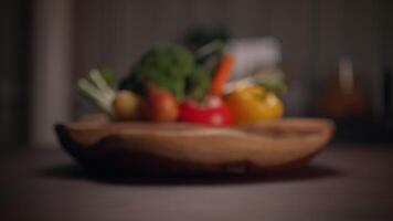 A beautiful assortment of fresh vegetables arranged elegantly in a rustic wooden bowl on a table video