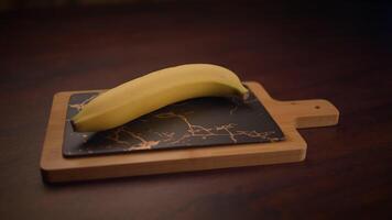 A banana beautifully placed on a cutting board featuring an elegant marble design background video