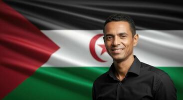 Confident man smiling in front of western sahara flag for cultural representation and unity photo