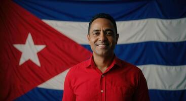 Portrait of a smiling man in front of cuban flag, celebrating national heritage and diversity photo