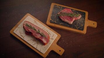 Fresh cuts of meat artistically arranged on wooden boards with herbs for flavor and presentation video