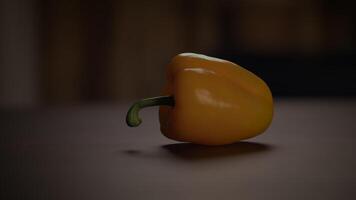 A Vibrant Yellow Bell Pepper Beautifully Placed on a Rustic Wooden Table Surface video