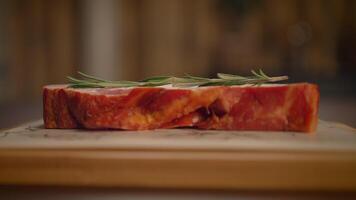A closeup of a presented, succulent meat cut, garnished with fresh herbs for flavor video
