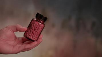 Generic prescription drugs on table top as macro camera moves slowly accross spilled pills and into the bottle. video