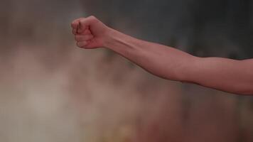 The Dynamic Gesture of a Fist Displayed Within an Engaging and Artistic Background video