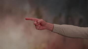 A captivating hand gesture is set against a vibrant and colorful background that delights the eye video
