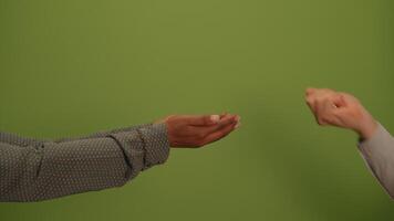 The hands are offering a sense of connection and warmth against a calming green background video
