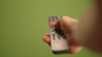 Remote Control Over a Vibrant Green Background for Enhanced User Interaction Experience video