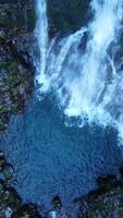 An Aerial View of a Beautiful Cascading Waterfall Flowing Gracefully into a Serene Pool video