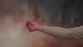 A hand gesture against a soft background, symbolizing interaction and expression video