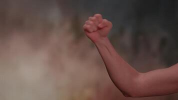 An Empowerment Gesture Symbolized by a Raised Fist Set Against an Inspiring, Dramatic Background video