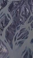 Aerial view of glacial river pattern. The amazing nature of Iceland. Beautiful nature background. vertical footage video