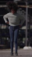 A person is bending down in an urban setting, dressed casually in comfortable attire video