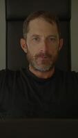 An intense portrait of a man in a modern setting, showcasing his deep emotions and thoughts video