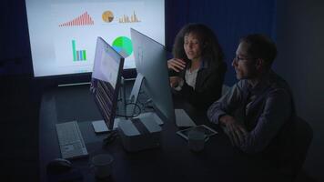 Engaging in Collaborative Data Analysis Within a Dimly Lit Office Environment Setting video