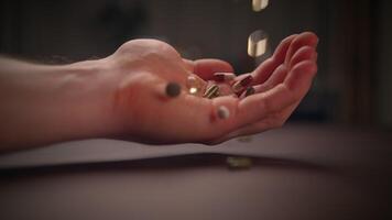 A closeup of a hand releasing objects that fall, showcasing beauty and harmony in motion video