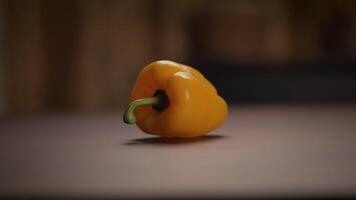 A Bright and Vibrant Yellow Bell Pepper Beautifully Displayed on a Rustic Wooden Surface video