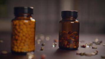 Vitamin bottles are arranged neatly on a wooden table, displaying various shapes and colors video