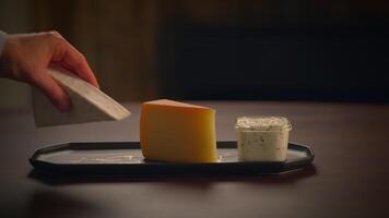 An Artistic Presentation of a Selection of Cheeses on a Rustic Wooden Table Setting video