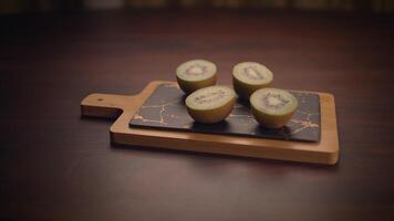 This is an image of Freshly Cut Kiwi that is beautifully arranged on a Stylish Cutting Board video
