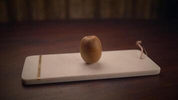 A Minimalist Artistic Display Featuring a Unique Object Gracefully Positioned on a Wooden Surface video