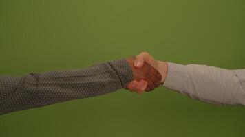 A hand gesture is presented against a vibrant green background, conveying openness and warmth video