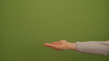 A Hand Gesture Set Against a Vibrant Green Background, Full of Artistic Potential and Meaning video