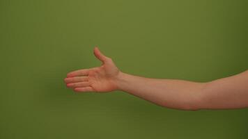 A Hand Gesture Displayed Against a Bright Green Background, Emphasizing Visual Communication video