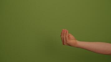 A Womans Hand is Gesturing Against a Vibrant and Lively Green Background Setting video