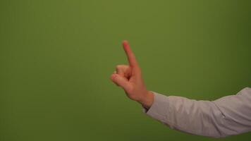 A Hand Pointing in a Clear Manner Against a Bright Green Background for Emphasis video