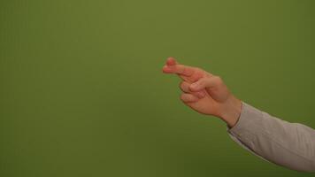 A Hand Gesture Displayed Against a Lively Green Background to Convey Meaningful Themes video
