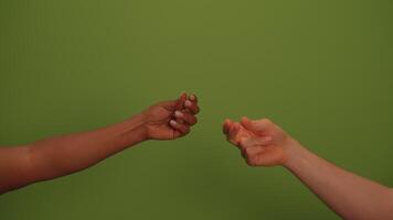 Two hands are engaged in a game of RockPaperScissors against a lively green background video