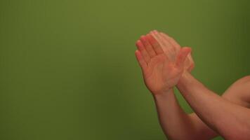 Clapping Hands Located Against a Vibrant Green Background in a Dynamic and Engaging Setting video