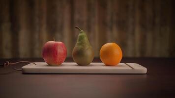 An Artistic Arrangement of Fresh Fruits on a Cutting Board Apple, Pear, and Orange video