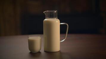 An Elegant Milk Jug and Glass Resting on a Beautiful Wooden Table in a Cozy Setting video