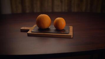 Fresh Oranges beautifully arranged on a rustic Wooden Cutting Board ready for use and enjoyment video