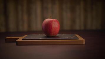A Fresh and Delicious Red Apple Presented on a Rustic Wooden Cutting Board Surface video
