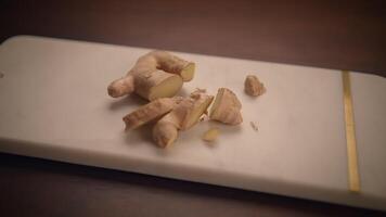 Freshly chopped Ginger Root placed on a wellused Cutting Board ready for use in meals video