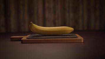A single ripe banana placed on a wooden cutting board in a cozy, inviting setting video