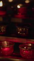 Beautifully Illuminated Red Candle Holders Glow Softly in the Gentle Surrounding Light video