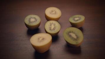 Delicious and Unique Kiwi Slices Arranged Beautifully on a Wooden Surface Background video