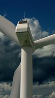 A CloseUp View of a Wind Turbine Set Against a Dramatic and Cloudy Sky Background video