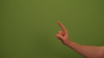 A hand gesture displayed against a vibrant green background makes a striking visual statement video