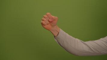 Hands in Action Displayed Against a Vibrant Green Background, Signifying Strength and Unity video