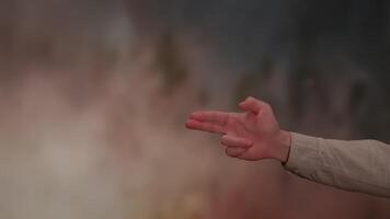A Dynamic Gesture of a Hand Showing Gun Pistole sign Set Against an Exuberantly Vibrant and Colorful Background video