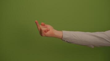 A Closeup of a Distinctive Hand Gesture Displayed Against a Vivid Green Background video