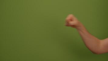 A Strong Fist Displayed Prominently Against a Bold Green Background for Maximum Impact video
