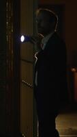 A Mysterious Figure Holding a Flashlight in a Dark and Ominous Setting During Nighttime video